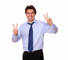 Cheerful adult smiling with victory sign