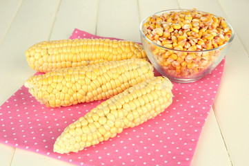 Fresh and dried corn on wooden background