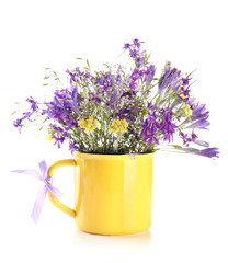 Beautiful bouquet of wildflowers in cup, isolated on white