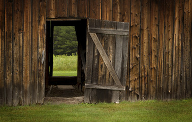 barn door open on green landscape