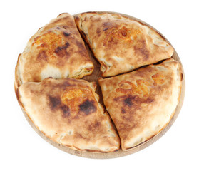 Pizza calzones on wooden board isolated on white