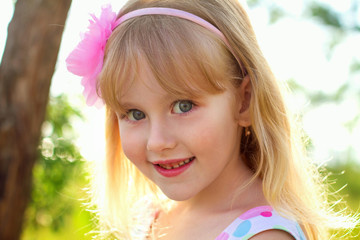 Fototapeta premium Portrait of pretty little girl outdoors