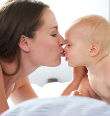 Mother kissing baby