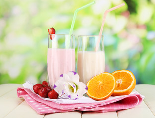 Delicious milk shakes with strawberries and orange