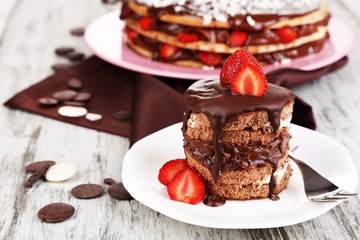 Chocolate cake with strawberry on wooden table close-up
