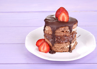 Chocolate cake with strawberry on wooden table close-up