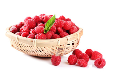 Ripe sweet raspberries in basket, isolated on white