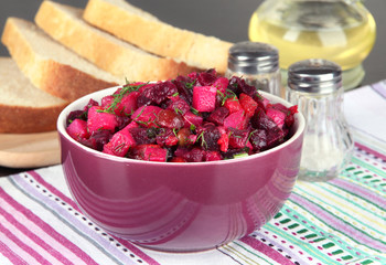 Beet salad in bowl on table close-up