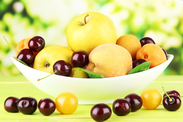 Naklejka na ściany i meble Bright summer fruits in plate