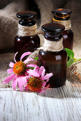 Medicine bottles with purple echinacea flowers