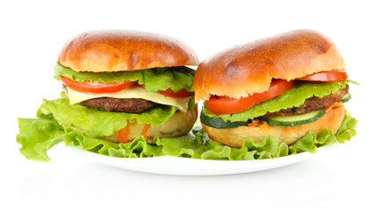 Big and tasty hamburgers on plate isolated on white