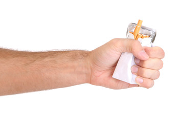 Fist with crushed pack of cigarettes, isolated on white