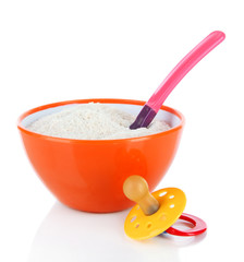 Powdered milk in bowl with spoon and nipple for baby isolated