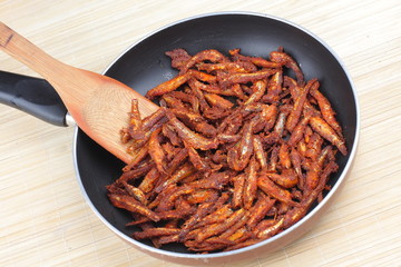 Anchovy fish fry in cooking pan.