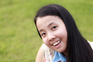 Asian woman smiling with grass