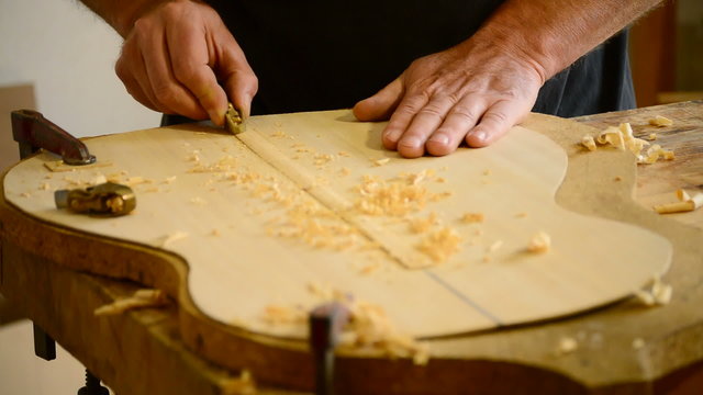 Luthier hands making a guitar