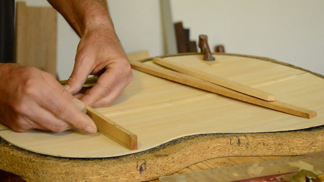 Luthier manufacturing a clasical guitar