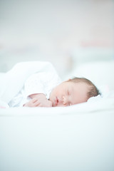 Newborn Baby Laying on White Bed