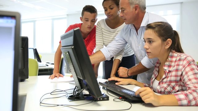 Teacher with students in computing class