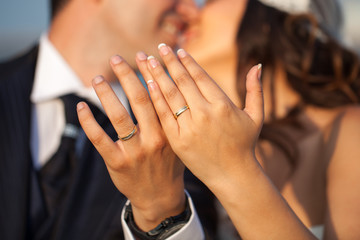 Closeup of hands of newlyweds showing their rings