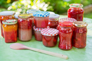 Fototapeta na wymiar Homemade strawberry jam in different jars