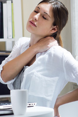 Woman with back pain at work