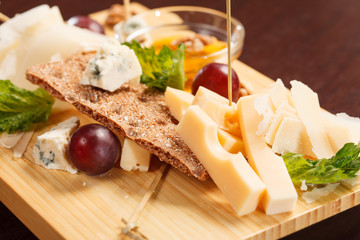 Cheese plate with grapes and honey