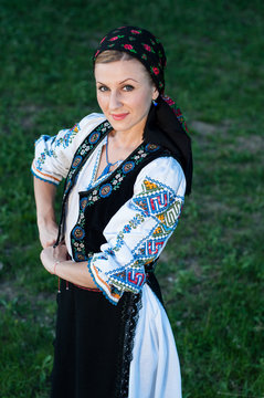 Young beautiful singer posing in traditional costume, romanian f