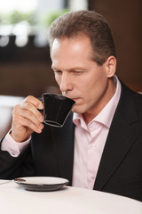 Businessmen at coffee break. Thoughtful mature men in formalwear