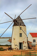 Fototapeta na wymiar old Windmill XVI century white stone and wood