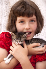 Little girl holding kitten