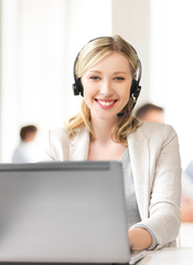 helpline operator with headphones in call centre