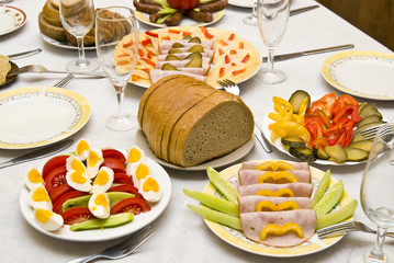 Festively covered table, with various dishes .
