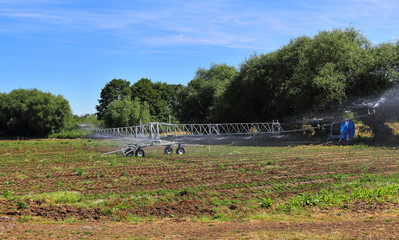 Field of Crops being watered with an irrigation machine