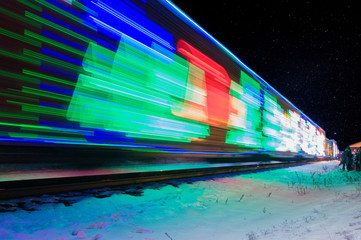 Train Decorated with Holiday Lights Arrives at Station