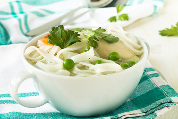 Chicken and rice  noodle soup  with peas
