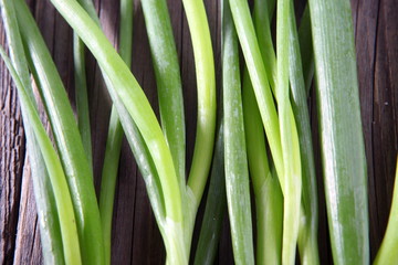 Spring onion on wooden board 