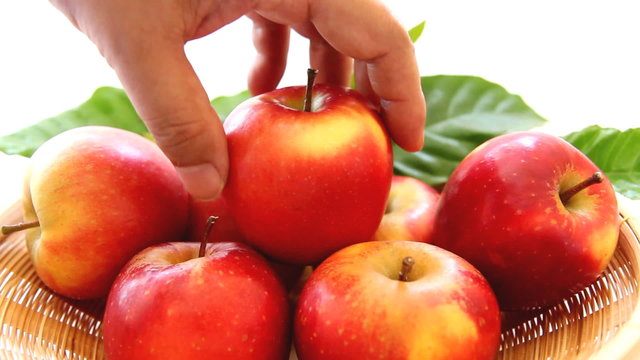 picking up red apple from the basket