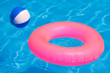 Pink pool float, pool ring in cool blue refreshing blue pool