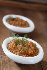 french aubergine eggplant caviar with oil  in white bowl on wood