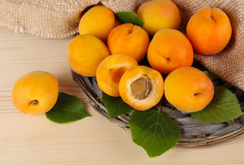 Apricots on wicker coasters on wooden table