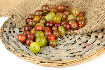 Fresh gooseberries on wicker mat close-up