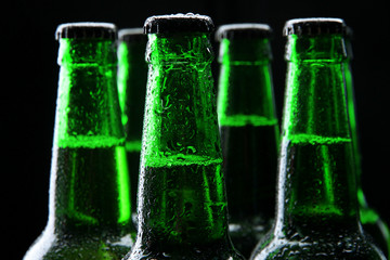 Bottles of beer on black background