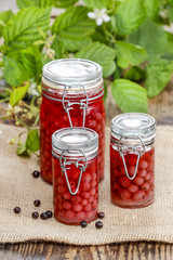 Glass jars of preserves on wooden table
