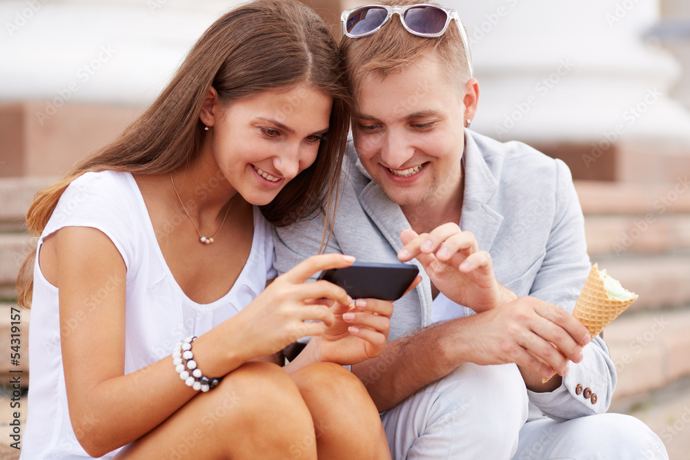 Poster couple with mobile phone