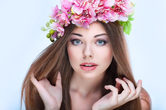 Hortrait of beautiful young girl with pink flowers