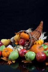 An overflowing cornucopia on a black background