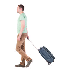 back view of walking  man  with suitcase.  brunette guy in motio