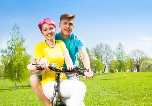 Smiling couple on the bike