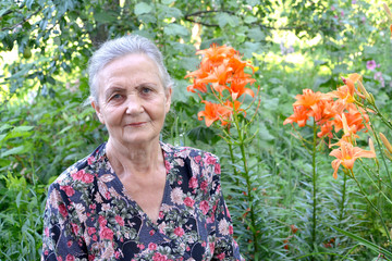 Portrait of the elderly woman in a garden